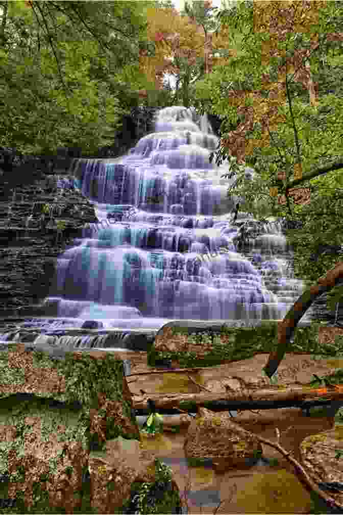 A Majestic Waterfall Cascading Down A Lush Cliff In Laos 5 Days In Laos Chris Backe