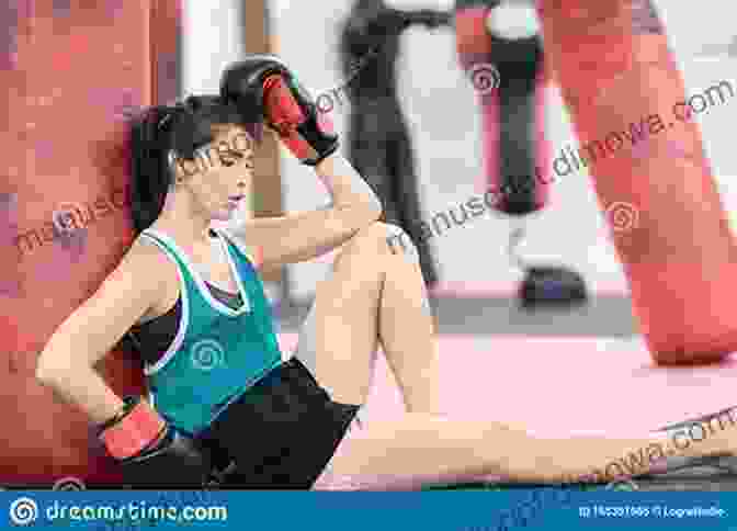 A Young Woman Sitting On A Mat, Wrestling With A Punching Bag. Wrestling Against Myself Katie Leone